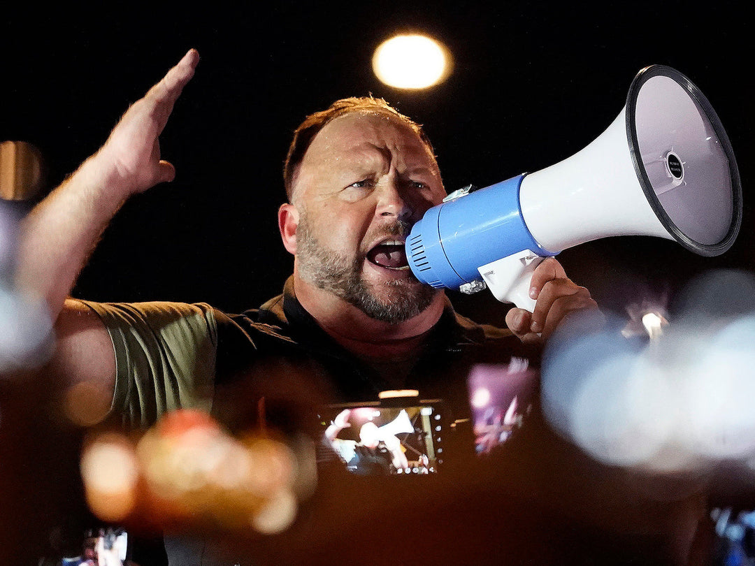 A jury has ordered conspiracy theorist Alex Jones to pay millions of dollars for spreading lies about the Sandy Hook school massacre. But his influence in right-wing media and politics remains strong. Matt York/AP